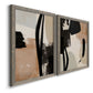 Angled view of a set of two gray barnwood framed canvas prints featuring two minimalist collage-like abstracts featuring black taupe cream and beige painted forms.