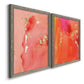 Angled view of a set of two gray barnwood framed canvas prints featuring two glamorous fluid abstracts featuring luminous coral orange and pink color fields with gold flecks.
