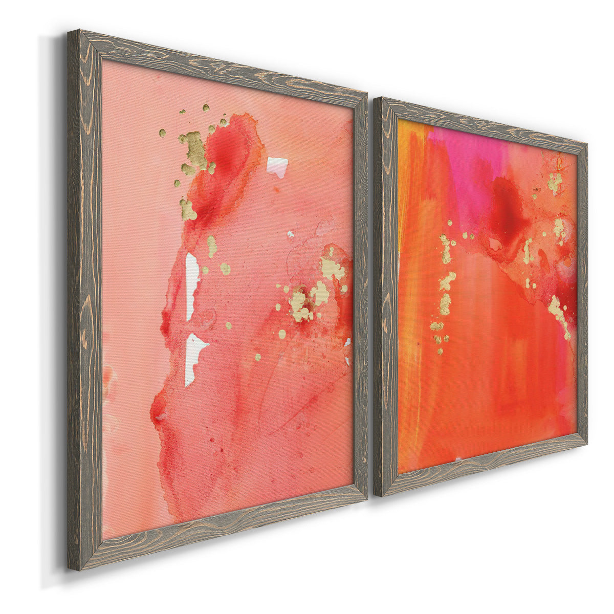 Angled view of a set of two gray barnwood framed canvas prints featuring two glamorous fluid abstracts featuring luminous coral orange and pink color fields with gold flecks.