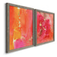 Angled view of a set of two gray barnwood framed canvas prints featuring two glamorous fluid abstracts featuring luminous coral orange and pink color fields with gold flecks.