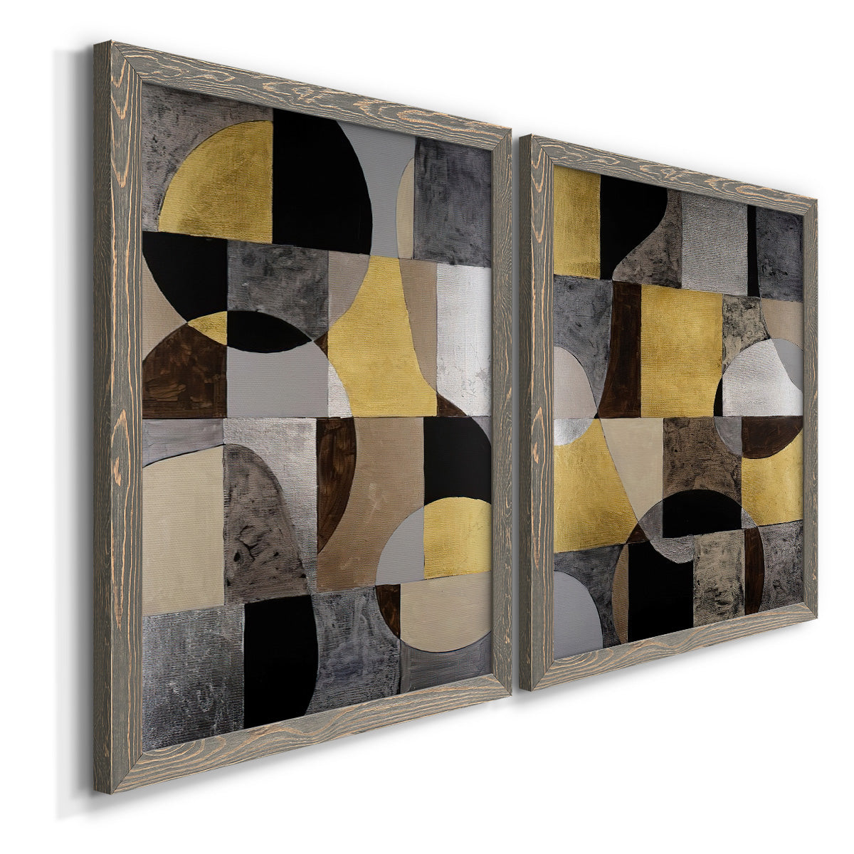 Angled view of a set of two gray barnwood framed canvas prints featuring two structured modern abstracts featuring interlocking black gray cream and gold geometric sections.