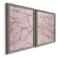 Angled view of a set of two gray barnwood framed canvas prints featuring two soft stone-inspired abstracts featuring pink marble veining with fine gold lines.