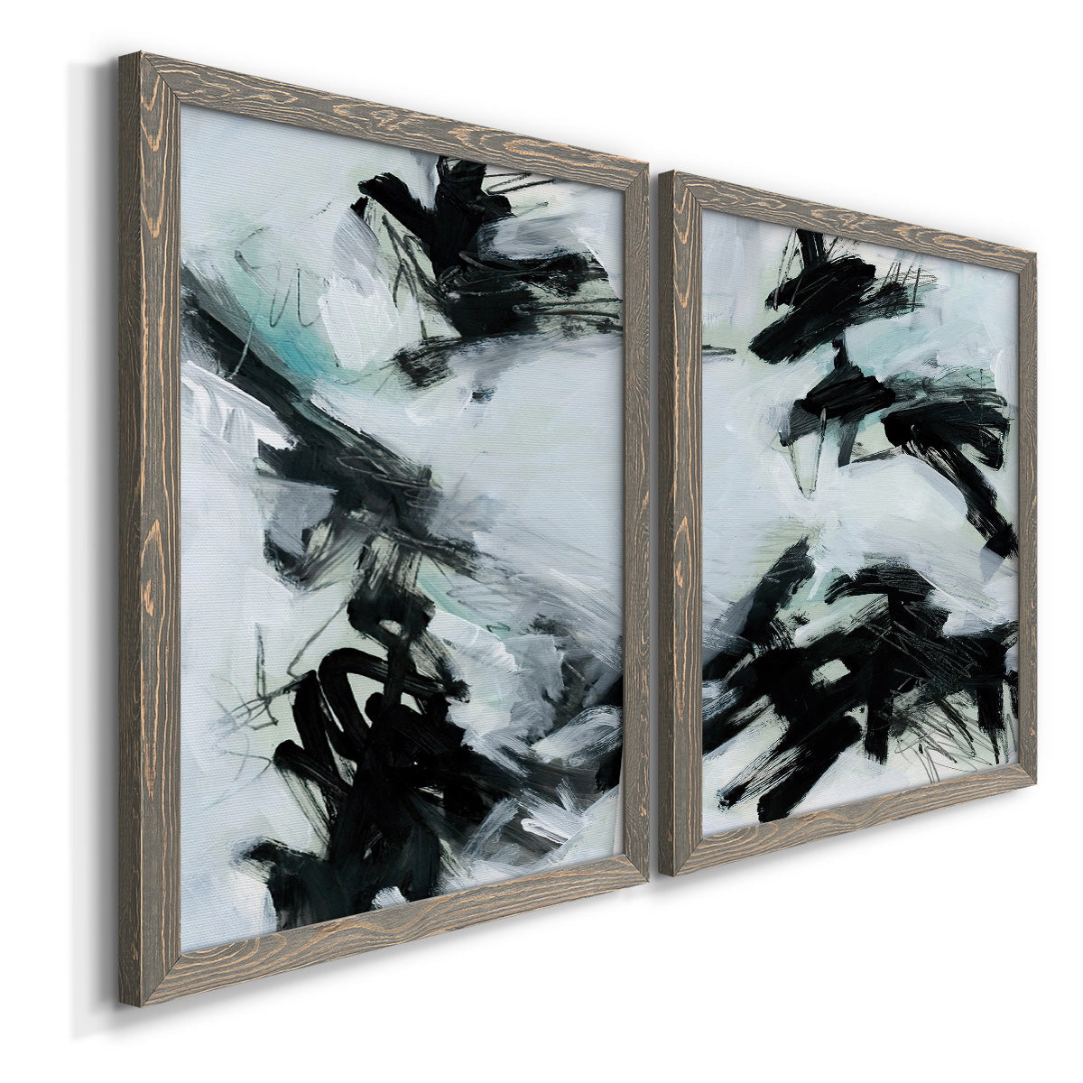 Angled view of a set of two gray barnwood framed canvas prints featuring two gestural ocean-inspired abstracts featuring sweeping black brushstrokes over pale blue-gray fields.