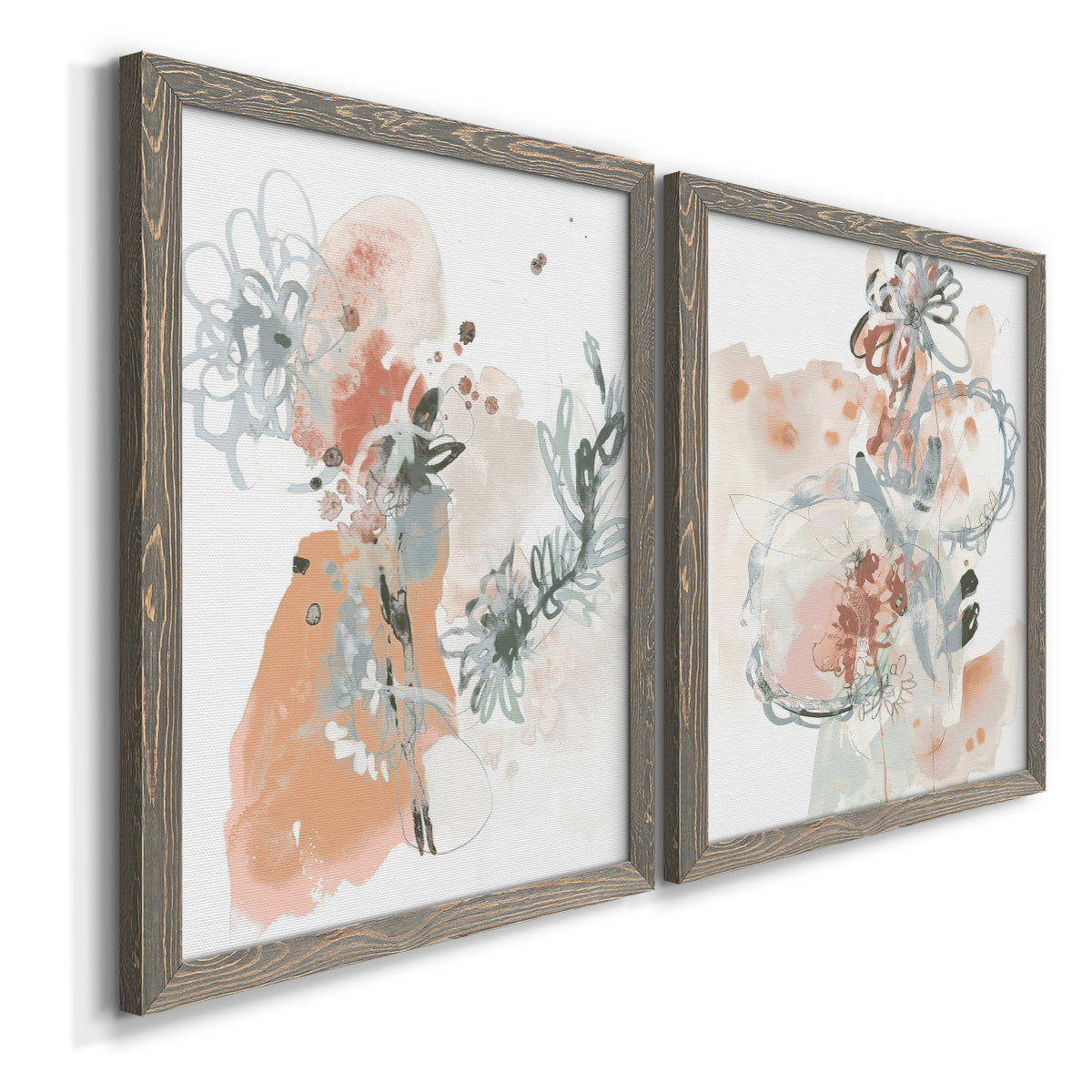 Angled view of a set of two gray barnwood framed canvas prints featuring two abstract watercolor botanicals featuring loose blush gray and coral floral gestures.