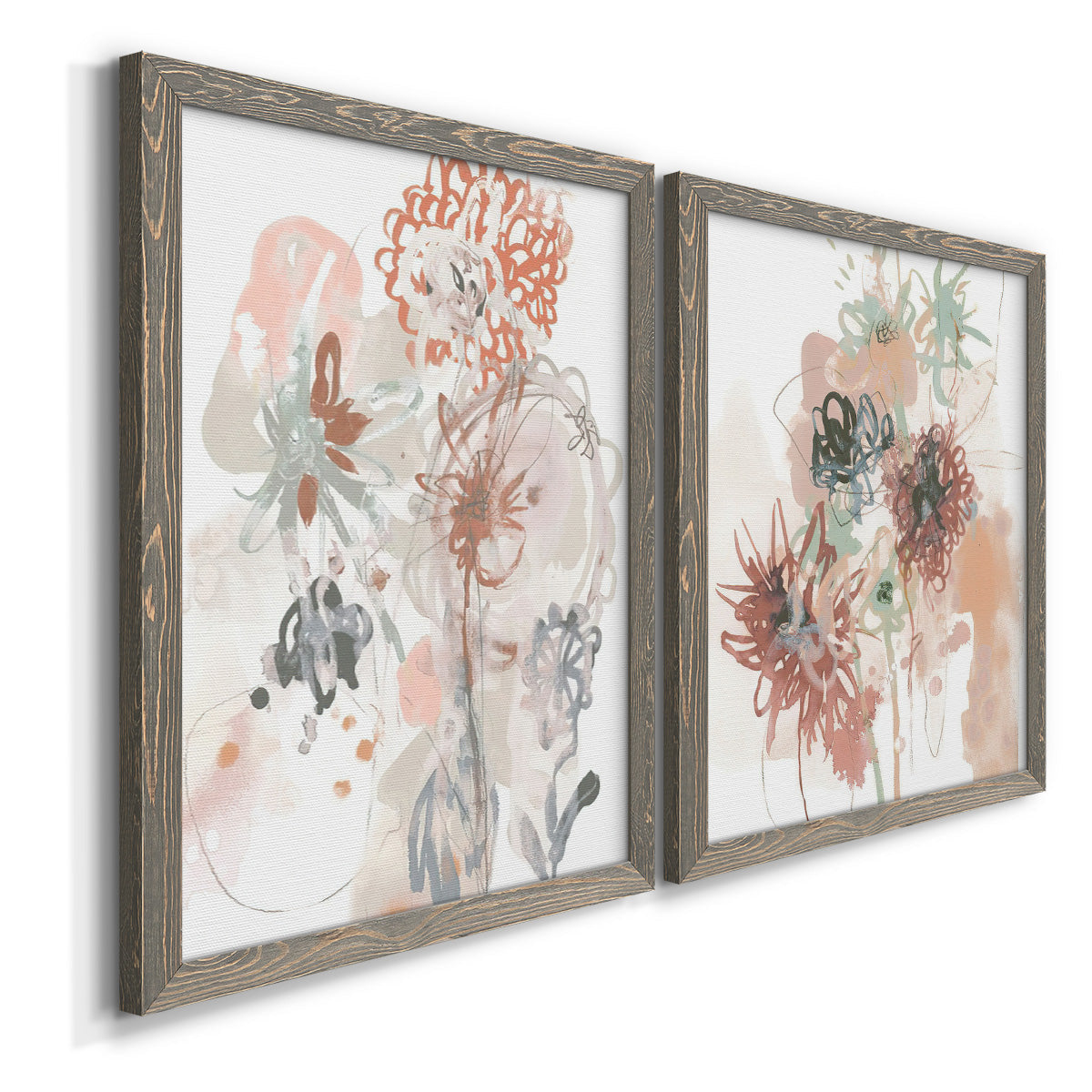 Angled view of a set of two gray barnwood framed canvas prints featuring two abstract watercolor botanicals featuring loose blush gray and coral floral gestures.
