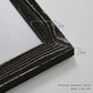 Close-up of the black barnwood frame corner and gallery-wrapped canvas construction.