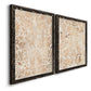 Angled view of a set of two black barnwood framed canvas prints featuring two vintage decorative prints featuring ornate cream floral damask patterns.