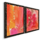 Angled view of a set of two black barnwood framed canvas prints featuring two glamorous fluid abstracts featuring luminous coral orange and pink color fields with gold flecks.