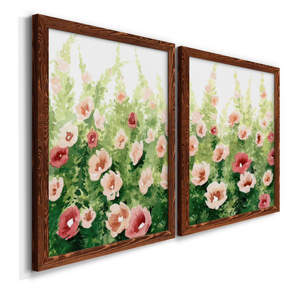 Angled view of a set of two maple barnwood framed canvas prints featuring two luminous impressionistic floral paintings featuring a field of pink coral and white flowers.