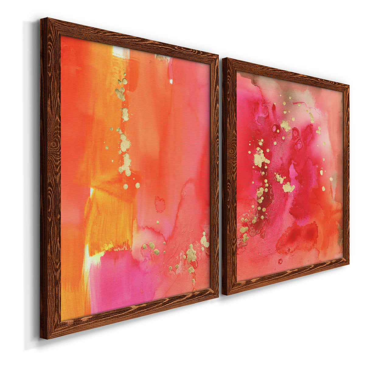 Angled view of a set of two maple barnwood framed canvas prints featuring two glamorous fluid abstracts featuring luminous coral orange and pink color fields with gold flecks.