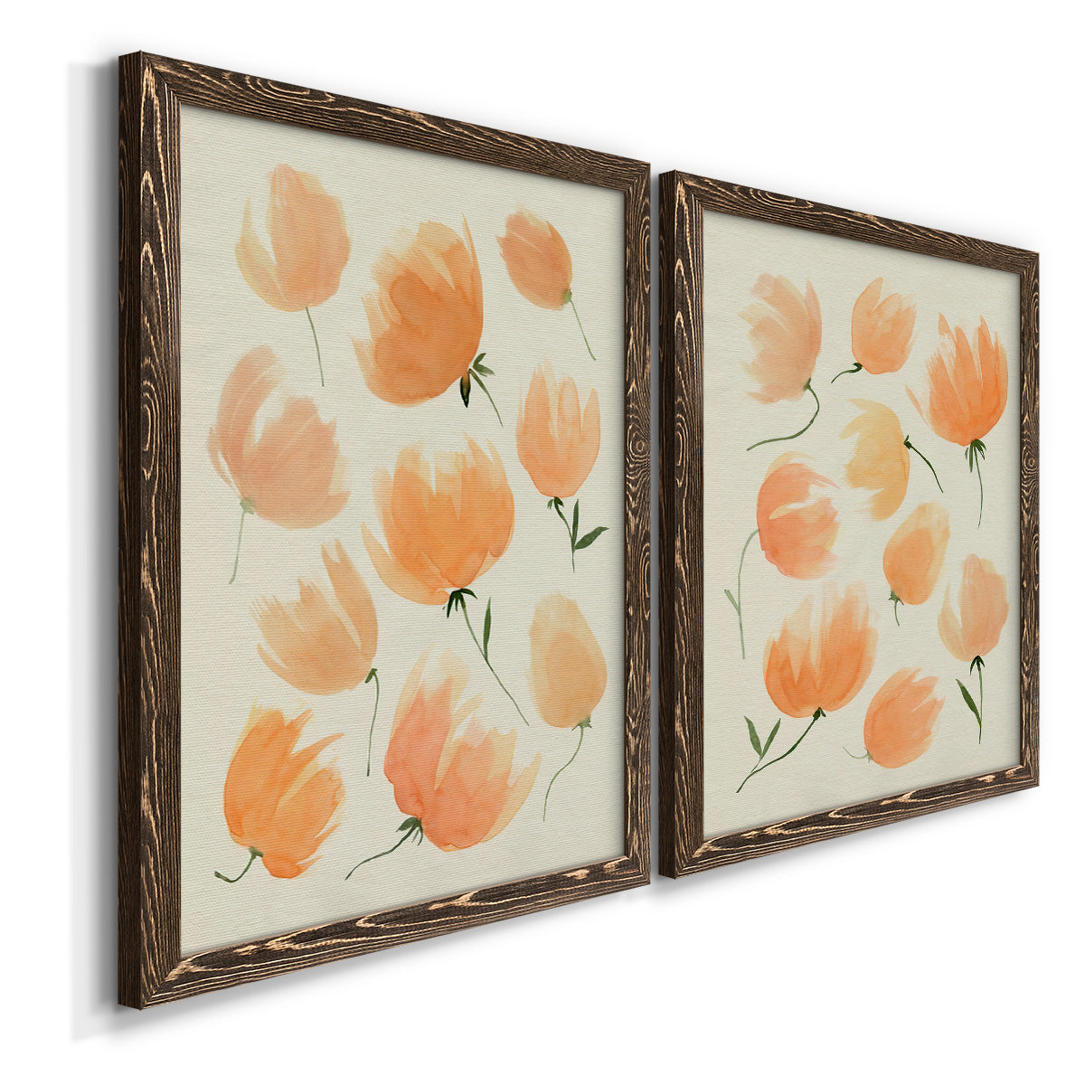 Angled view of a set of two walnut barnwood framed canvas prints featuring two airy watercolor floral paintings featuring loose peach-orange tulip-like blossoms.