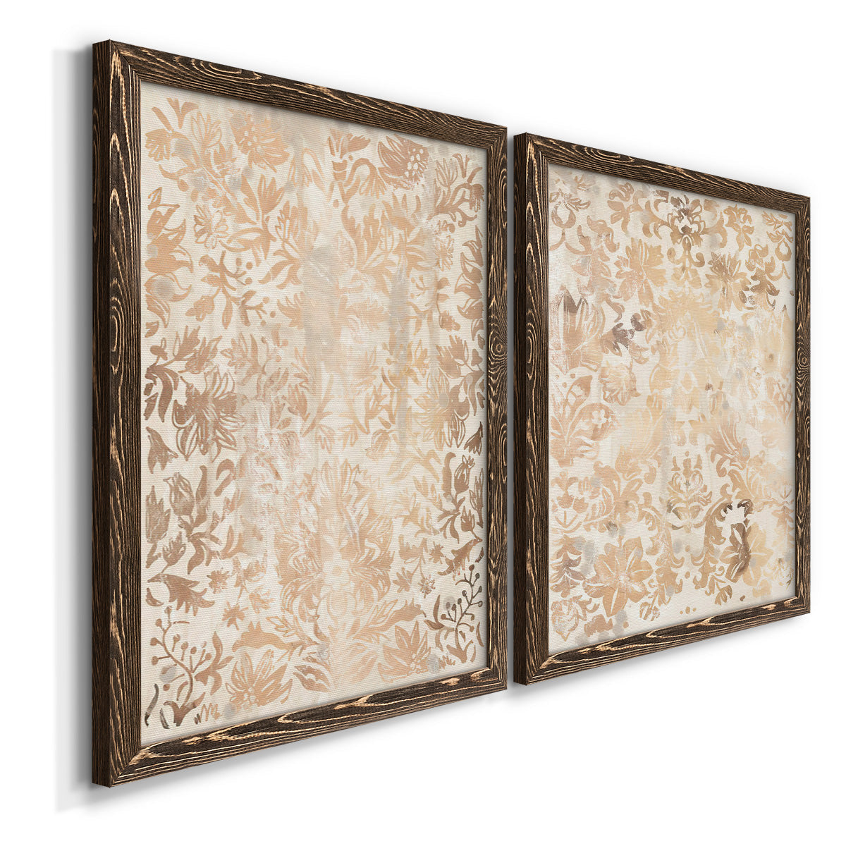 Angled view of a set of two walnut barnwood framed canvas prints featuring two vintage decorative prints featuring ornate cream floral damask patterns.