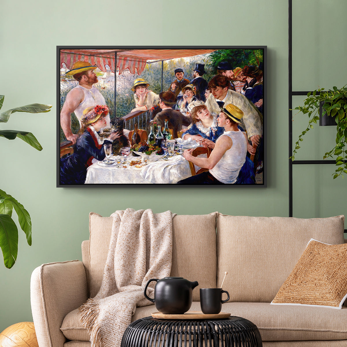 Black floater framed canvas featuring a social dining scene with figures seated around table on riverside terrace, displayed above a sofa in a modern living room.