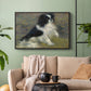Black floater framed canvas featuring an animal portrait of a dog in natural outdoor setting with soft light, displayed above a sofa in a modern living room.