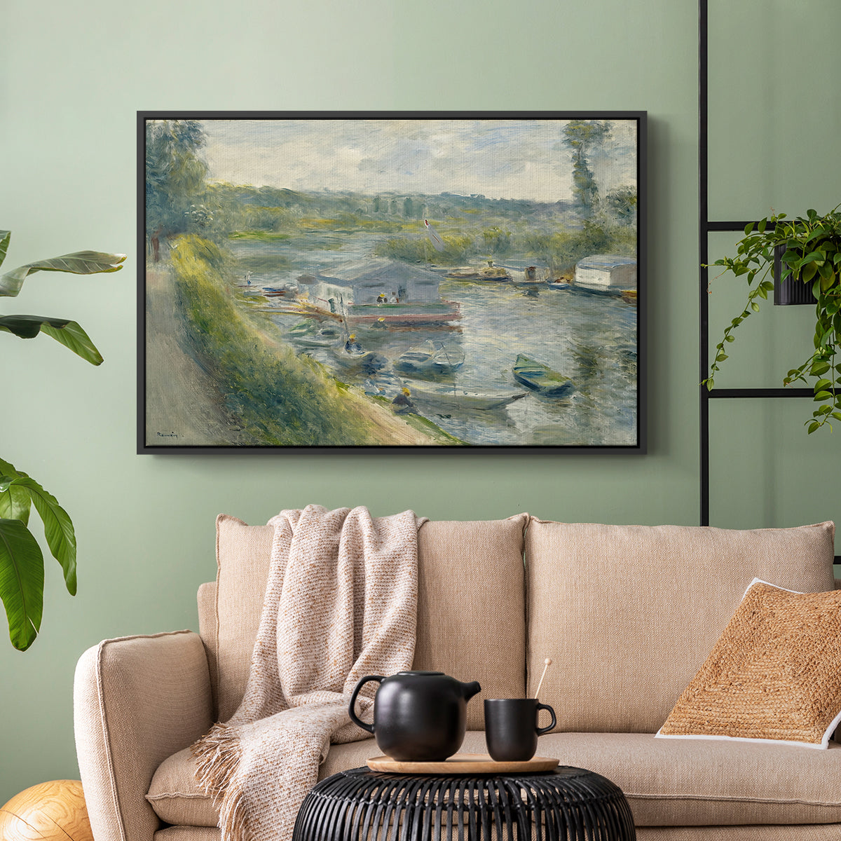Black floater framed canvas featuring an everyday life scene with boat and figures along river edge, displayed above a sofa in a modern living room.
