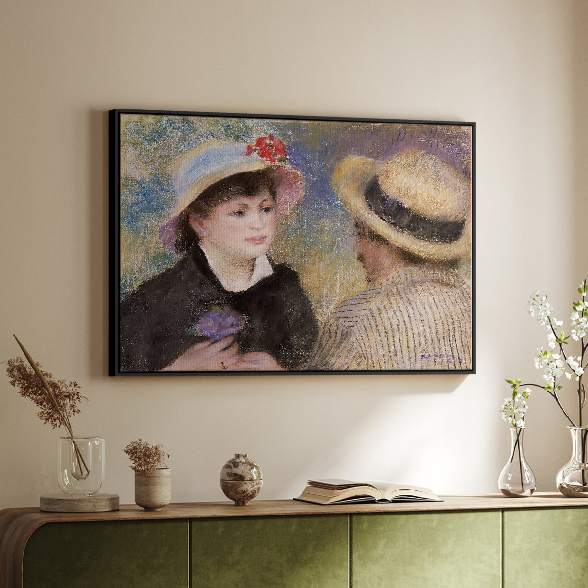 Black floater framed canvas of Boating Couple (Aline Charigot and Renoir), c. 1881 by Pierre-Auguste Renoir, featuring an intimate portrait of man and woman sitting side by side in outdoor setting above a sideboard in a softly lit hallway.