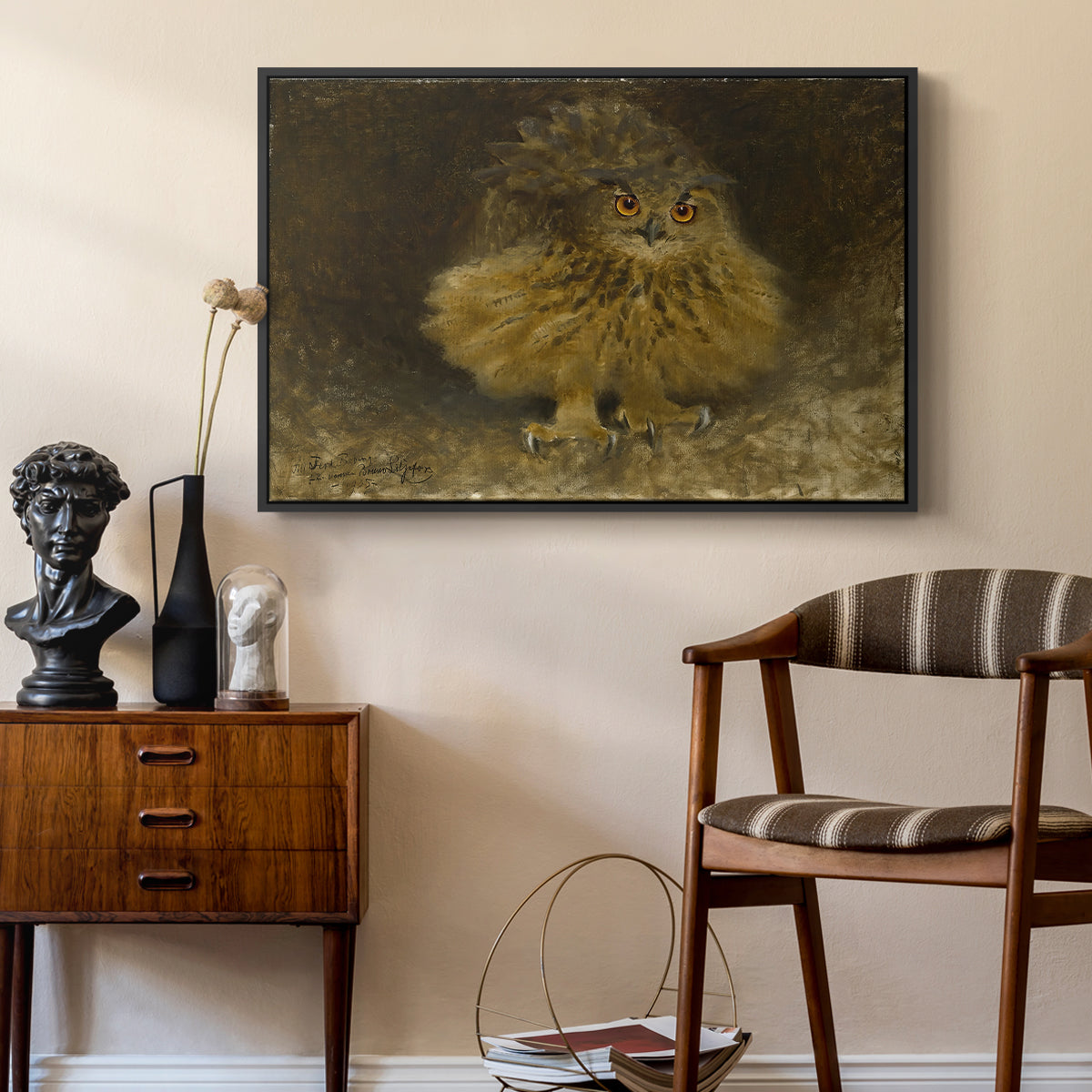 An Eagle Owl (Berguv), 1905 by Bruno Liljefors as a black floater framed canvas featuring a bird of prey resting on tree branch with textured feathers, styled above a mid-century console in a contemporary living area.
