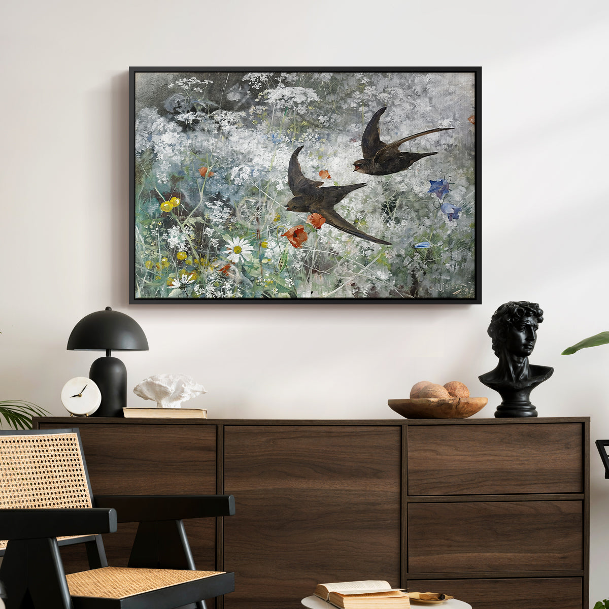 Common Swifts, 1886 by Bruno Liljefors displayed in a black floater framed canvas above a dark wood credenza in an entryway.
