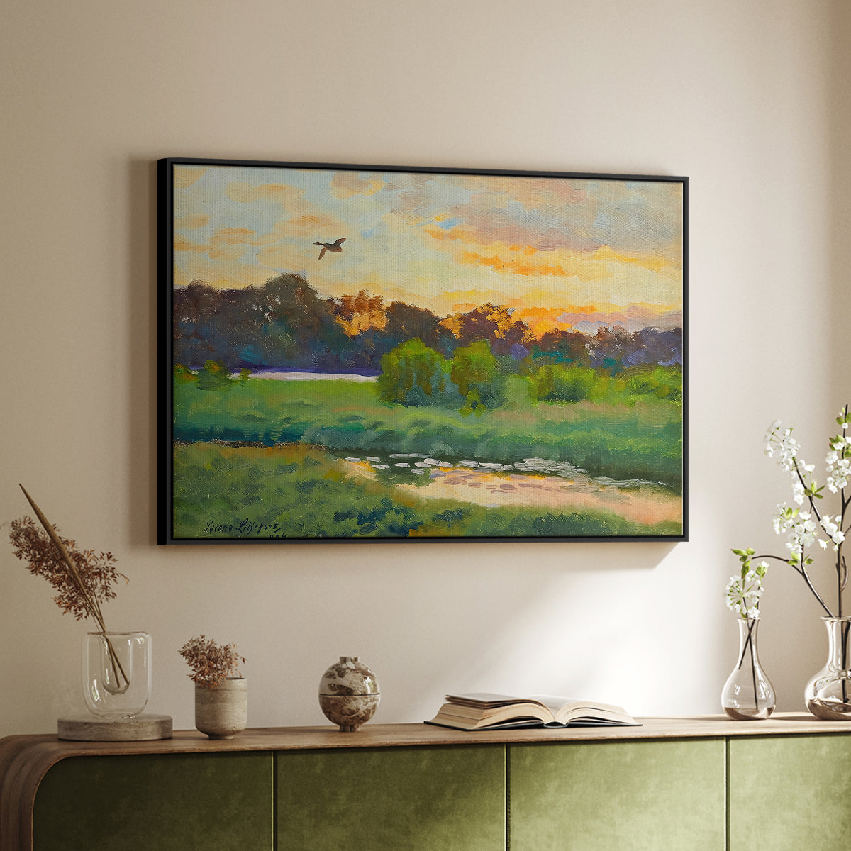 Black floater framed canvas of Flying Duck at Sunset, 1924 by Bruno Liljefors, featuring a lone duck soaring over a glowing marshland above a sideboard in a softly lit hallway.