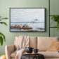 Black floater framed canvas featuring a flock of geese positioned along marshy terrain, displayed above a sofa in a modern living room.