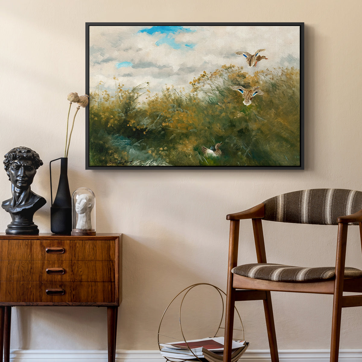 Wild Ducks (Grasänder), 1890 by Bruno Liljefors as a black floater framed canvas featuring a group of ducks foraging in natural marsh setting, styled above a mid-century console in a contemporary living area.