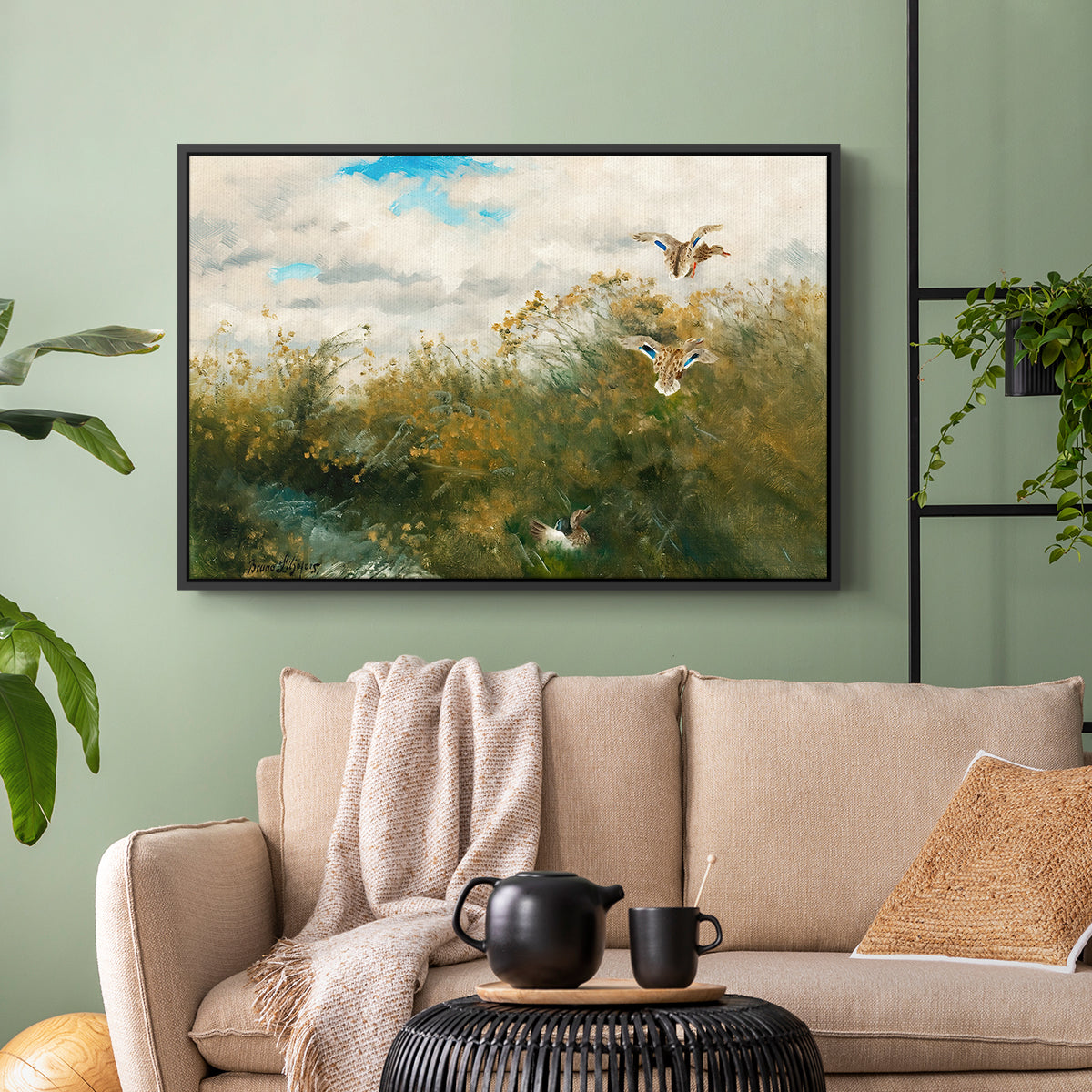 Black floater framed canvas featuring a realistic depiction of ducks in countryside landscape, displayed above a sofa in a modern living room.