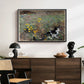 Cat on a Flowery Meadow, 1887 by Bruno Liljefors displayed in a black floater framed canvas above a dark wood credenza in an entryway.