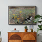 Cat on a Flowery Meadow, 1887 by Bruno Liljefors in a black floater framed canvas featuring a cat crouching in a meadow filled with wildflowers and greenery, displayed above a wood console cabinet.