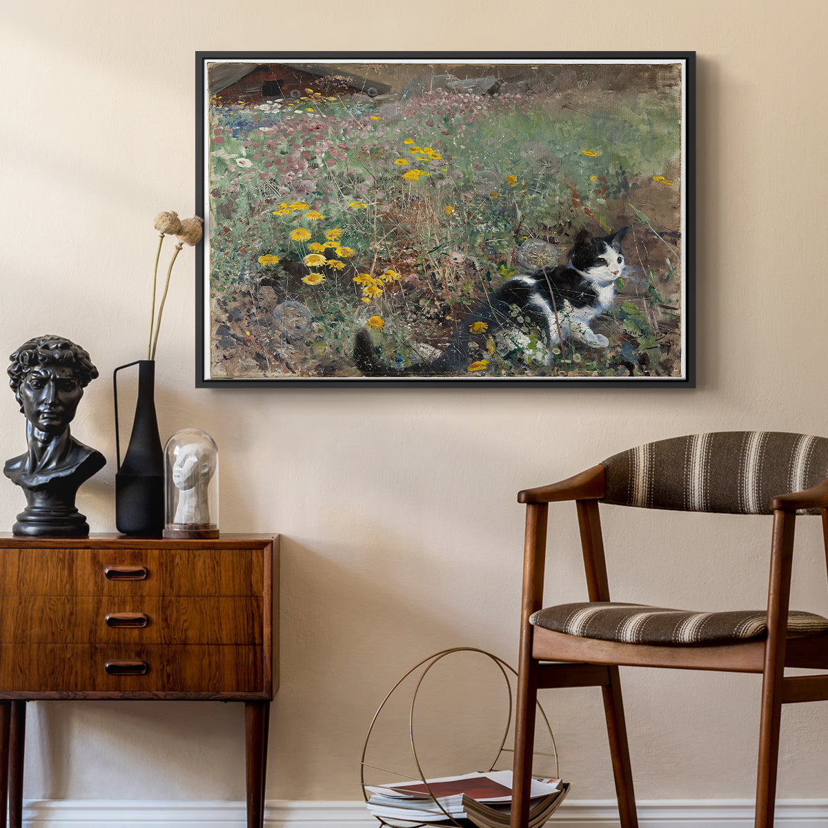Cat on a Flowery Meadow, 1887 by Bruno Liljefors as a black floater framed canvas featuring an animal scene of cat hidden in lush meadow vegetation, styled above a mid-century console in a contemporary living area.