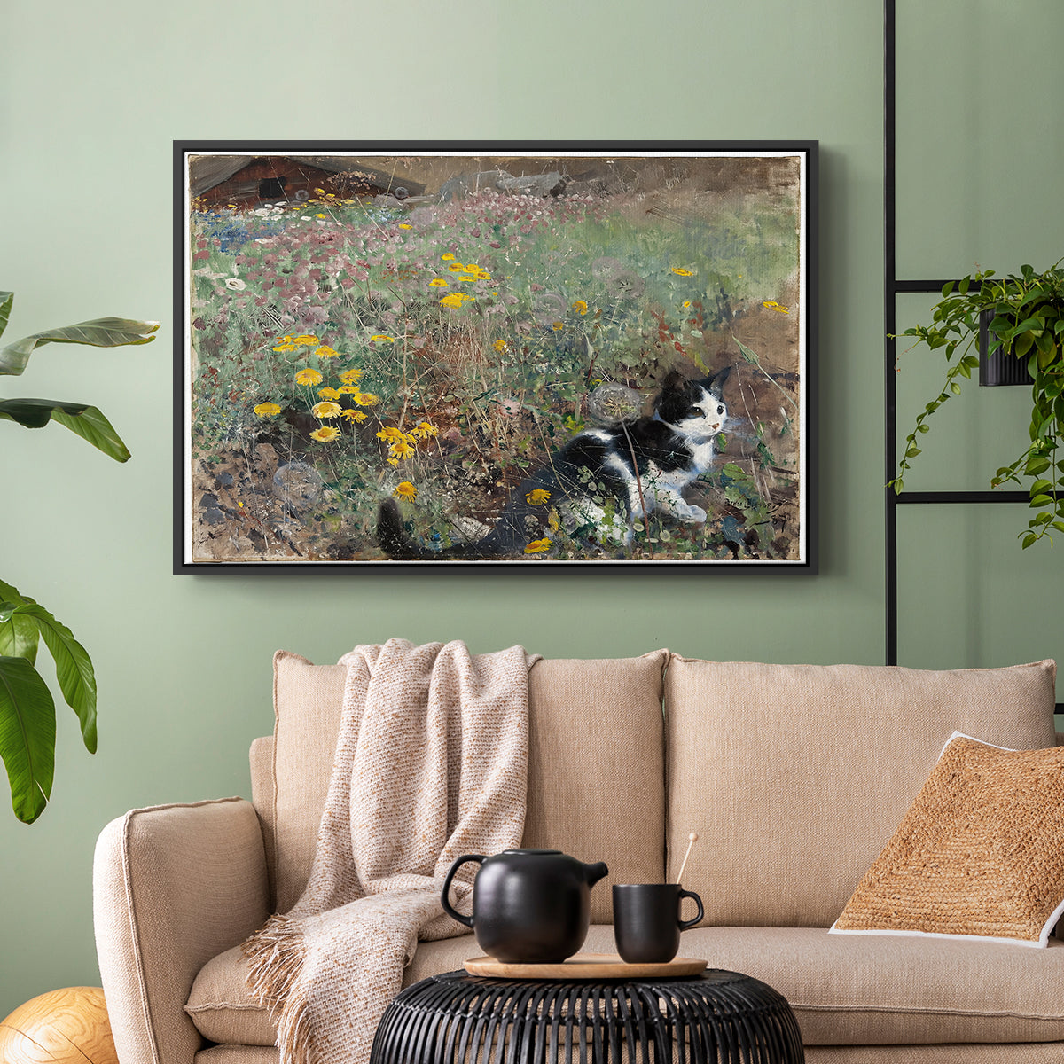 Black floater framed canvas featuring a naturalistic depiction of cat in blooming countryside setting, displayed above a sofa in a modern living room.