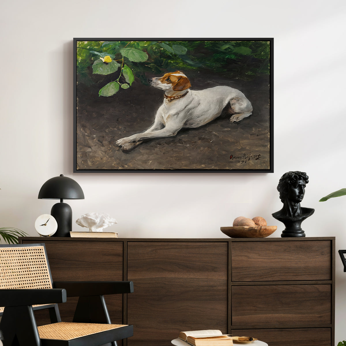 Portrait of a Dog, 1891 by Bruno Liljefors displayed in a black floater framed canvas above a dark wood credenza in an entryway.