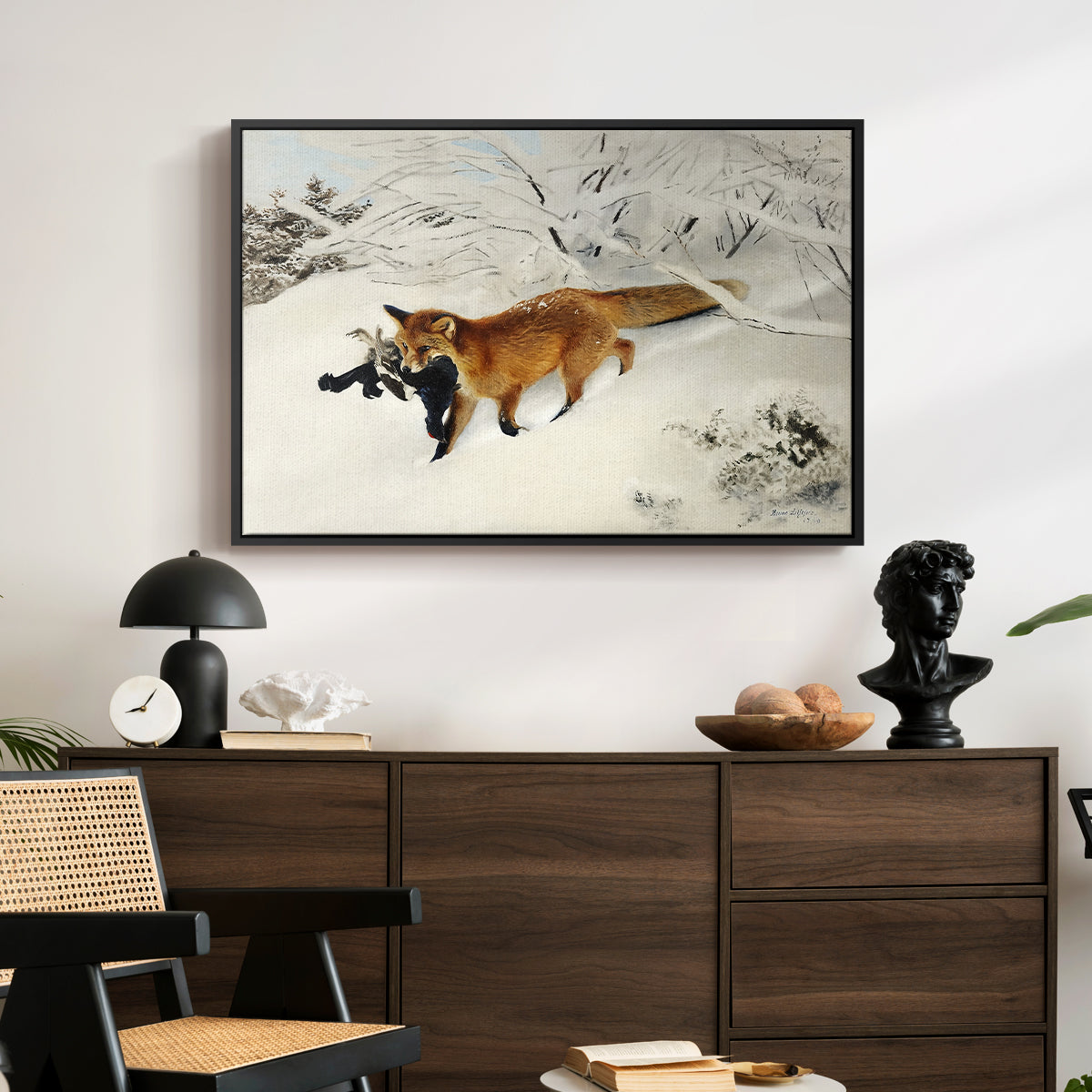 Fox in Snow Landscape, 1900 by Bruno Liljefors displayed in a black floater framed canvas above a dark wood credenza in an entryway.
