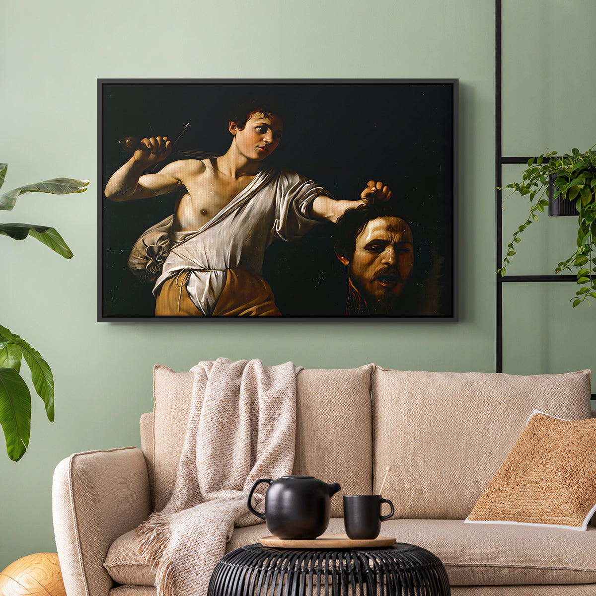Black floater framed canvas featuring an intense religious scene with figure emerging from darkness holding trophy, displayed above a sofa in a modern living room.