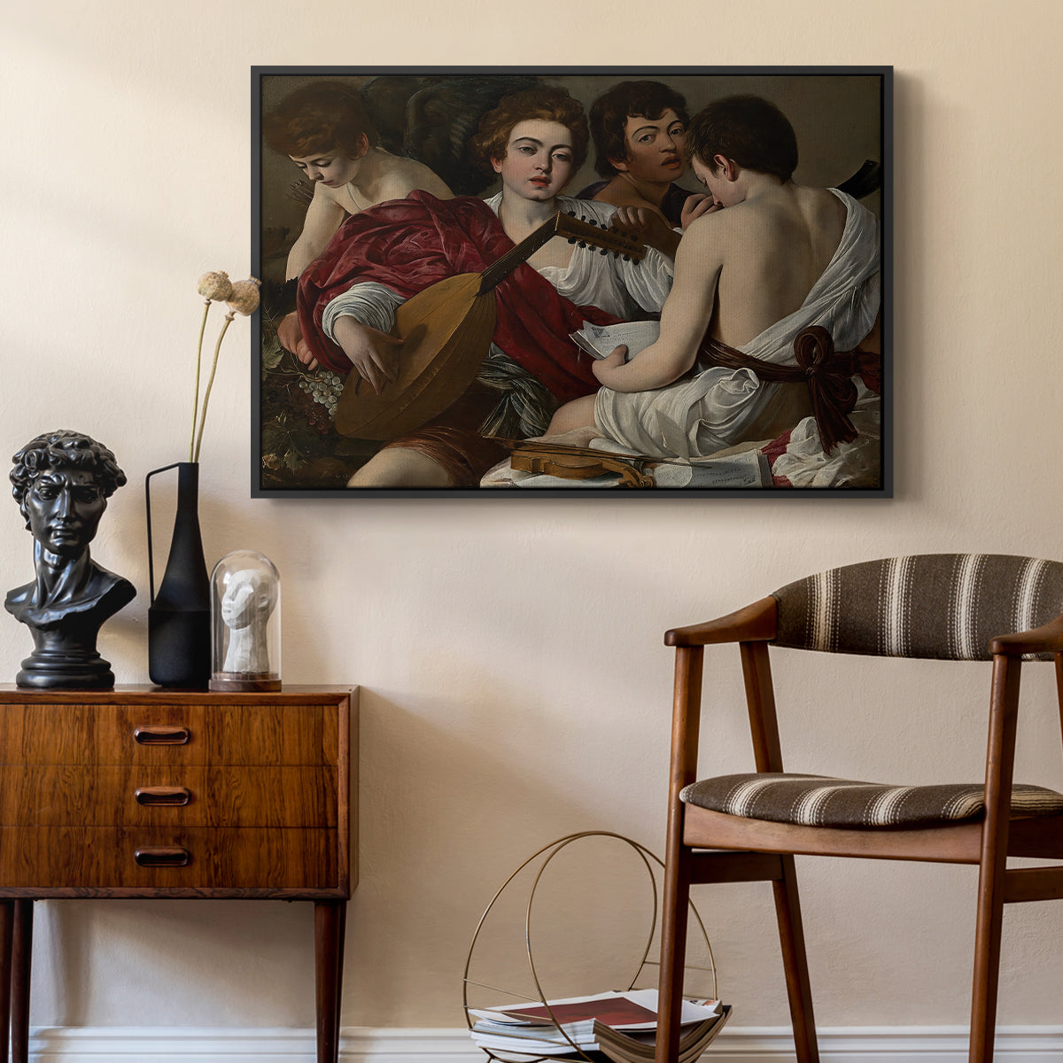 The Musicians, c. 1595 by Caravaggio as a black floater framed canvas featuring an intimate scene of youths making music with sheet music and instruments, styled above a mid-century console in a contemporary living area.