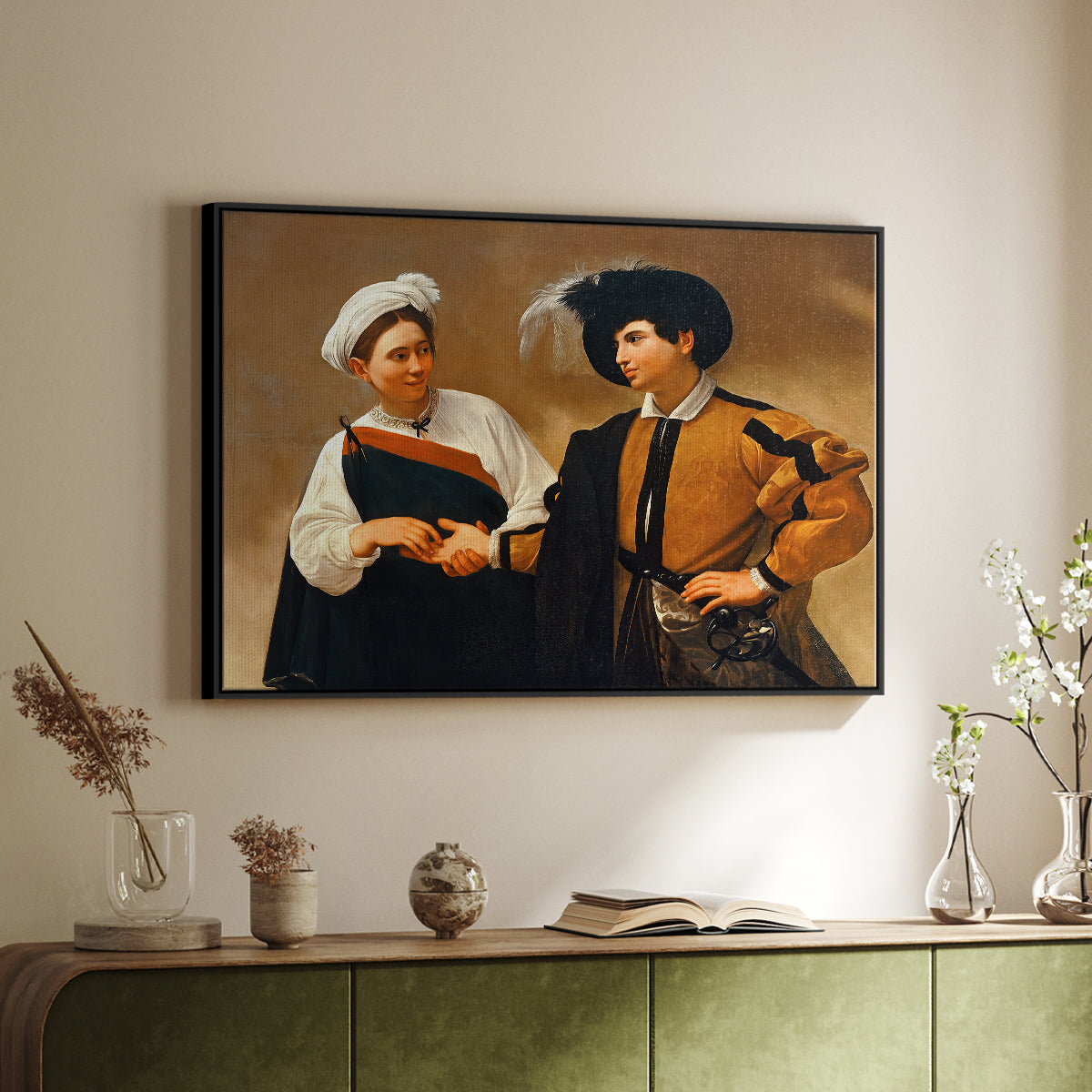 Black floater framed canvas of The Fortune Teller (Capitoline Version), c. 1599 by Caravaggio, featuring a fortune teller tricking young man during palm reading above a sideboard in a softly lit hallway.