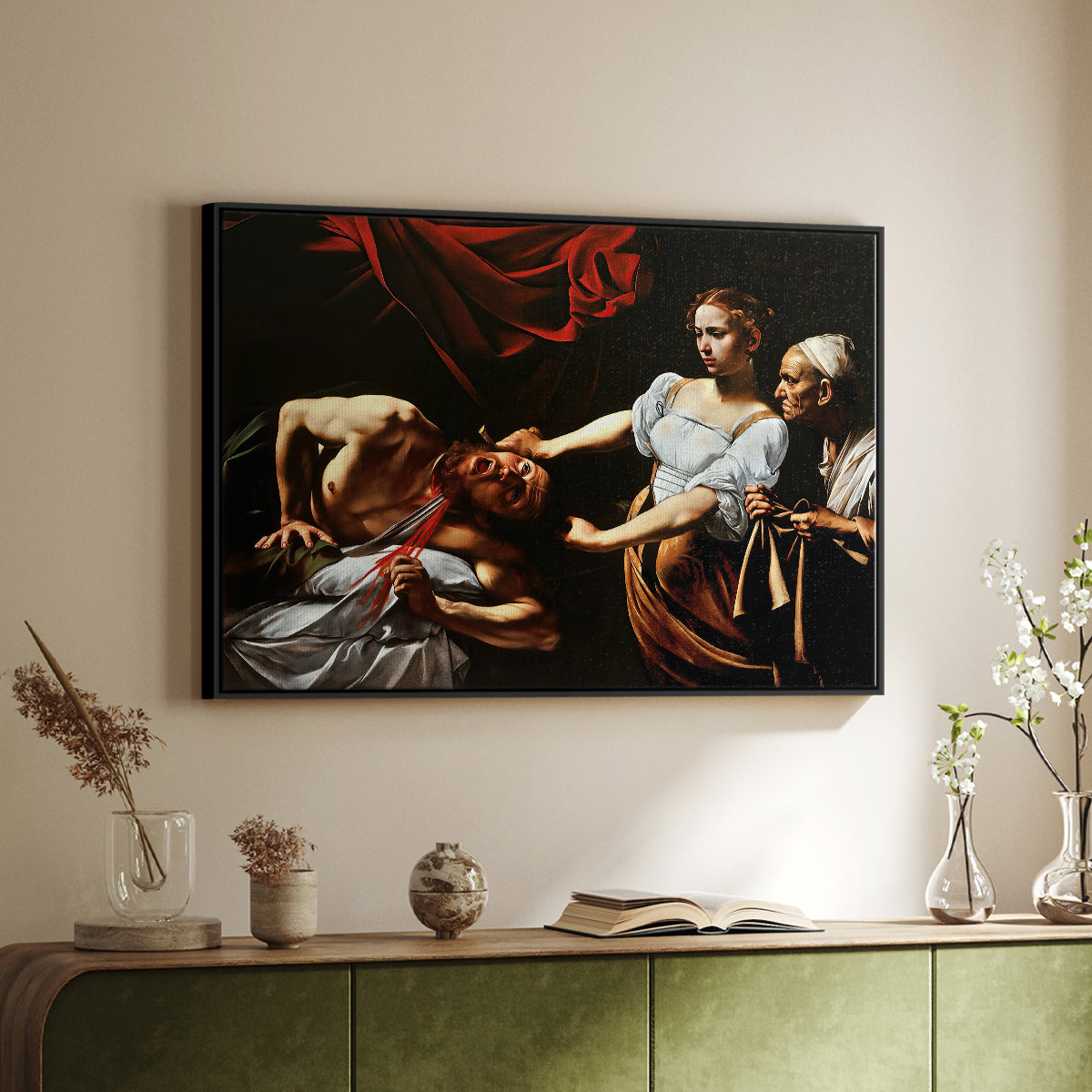 Black floater framed canvas of Judith Beheading Holofernes, c. 1599 by Caravaggio, featuring a dramatic biblical scene of woman beheading man in bed above a sideboard in a softly lit hallway.