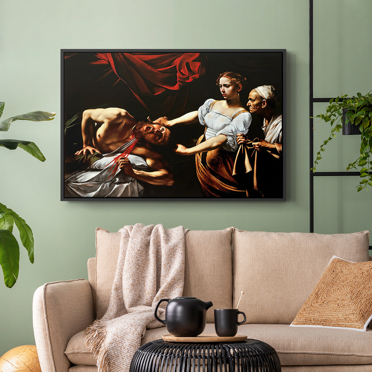 Black floater framed canvas featuring a violent religious narrative with strong contrast of light and shadow, displayed above a sofa in a modern living room.