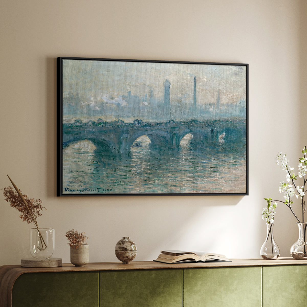 Black floater framed canvas of Waterloo Bridge, Gray Weather, 1900 by Claude Monet, featuring an impressionist cityscape with bridge fading into fog over water above a sideboard in a softly lit hallway.