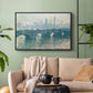 Black floater framed canvas featuring an atmospheric urban landscape with misty light and reflections, displayed above a sofa in a modern living room.