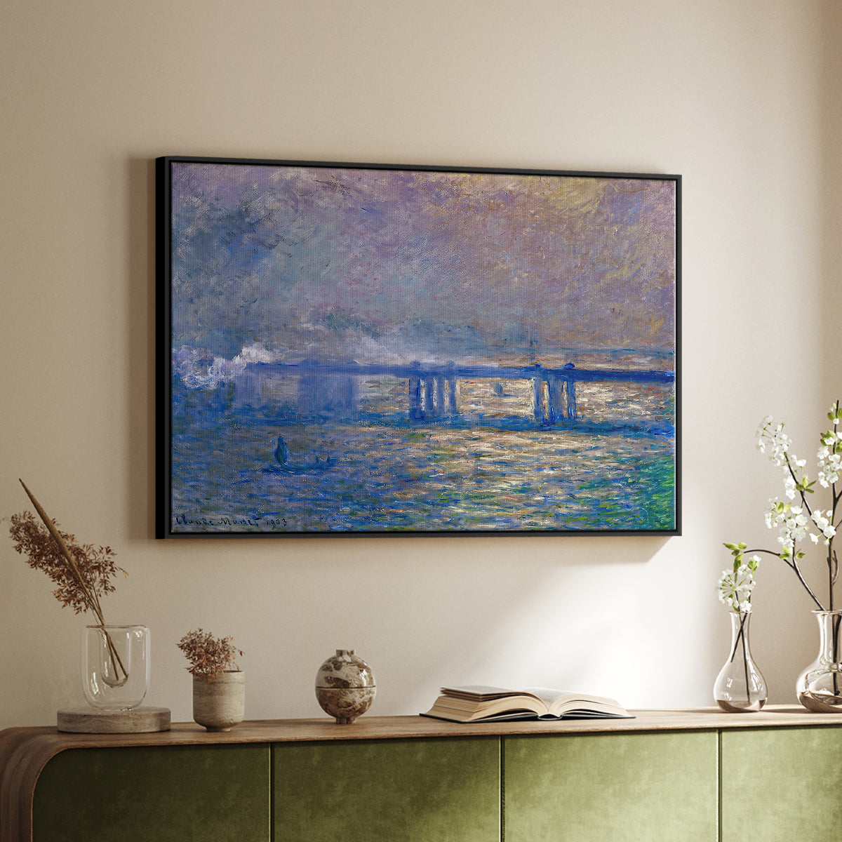 Black floater framed canvas of Charing Cross Bridge, 1903 by Claude Monet, featuring an urban landscape with bridge and water rendered in blurred tones above a sideboard in a softly lit hallway.