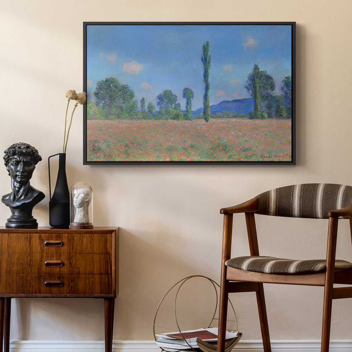 Poppy Field (Giverny), 1890-1891 by Claude Monet as a black floater framed canvas featuring a vibrant meadow scene with flowers and vertical tree forms, styled above a mid-century console in a contemporary living area.
