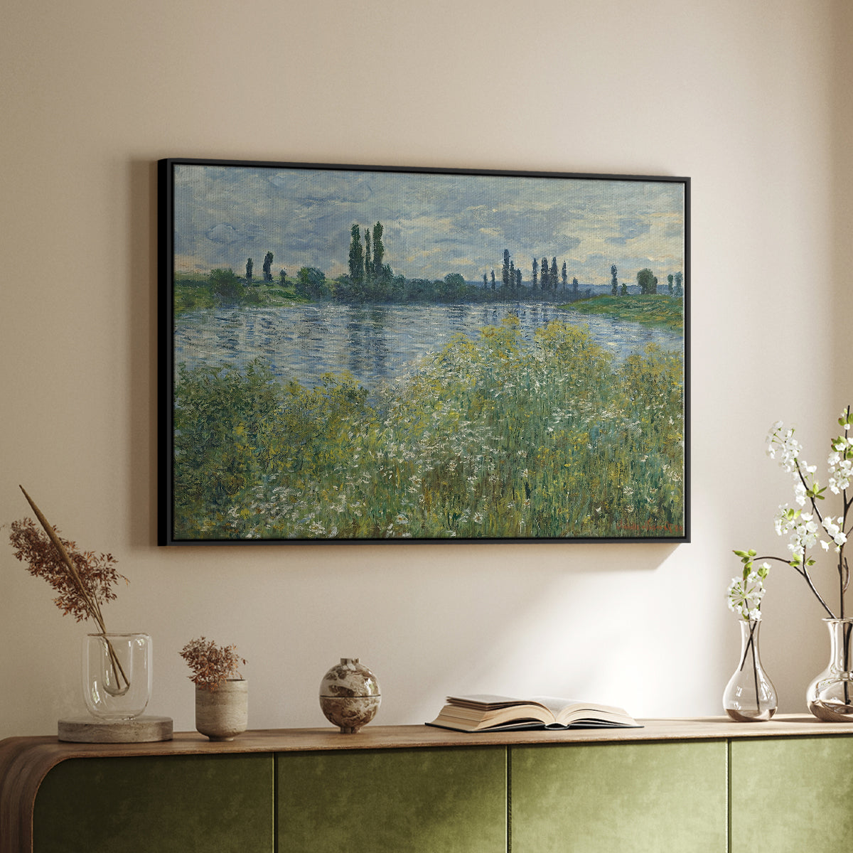 Black floater framed canvas of Banks of the Seine, Vétheuil, 1880 by Claude Monet, featuring an impressionist view of Seine with reflections and greenery above a sideboard in a softly lit hallway.