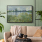 Black floater framed canvas featuring a natural landscape with calm water and soft foliage, displayed above a sofa in a modern living room.
