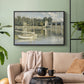 Black floater framed canvas featuring a riverside view with architecture and nautical activity, displayed above a sofa in a modern living room.