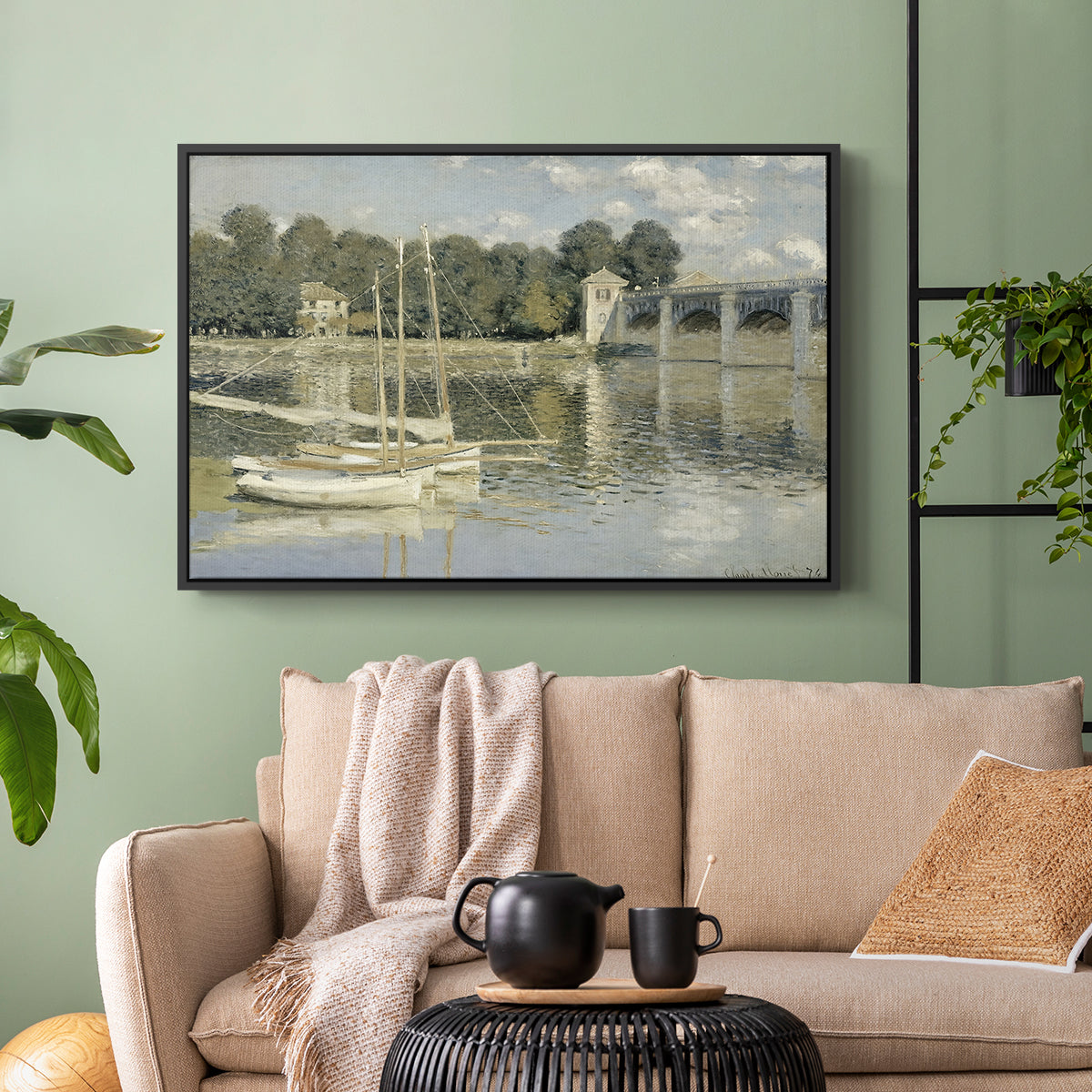 Black floater framed canvas featuring a riverside view with architecture and nautical activity, displayed above a sofa in a modern living room.