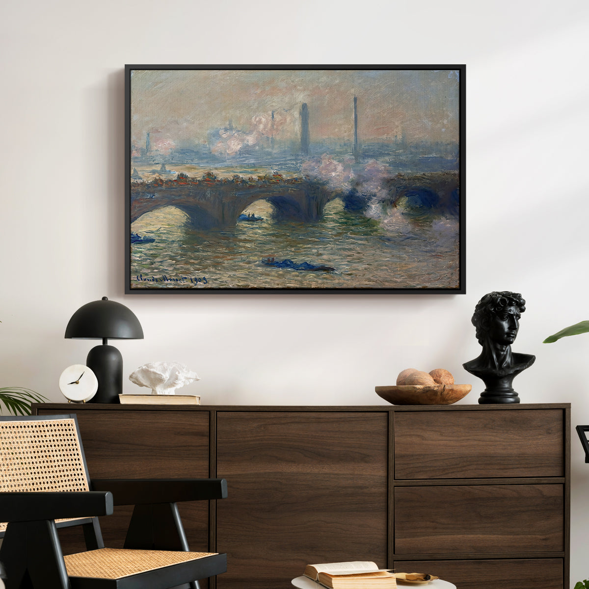 Waterloo Bridge, Gray Day, 1903 by Claude Monet displayed in a black floater framed canvas above a dark wood credenza in an entryway.