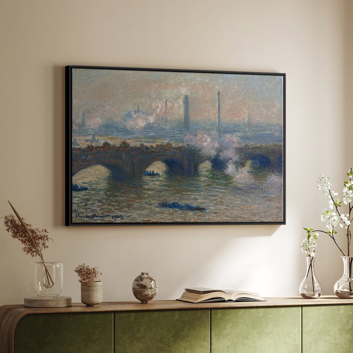 Black floater framed canvas of Waterloo Bridge, Gray Day, 1903 by Claude Monet, featuring an impressionist depiction of bridge with soft gray tones and haze above a sideboard in a softly lit hallway.
