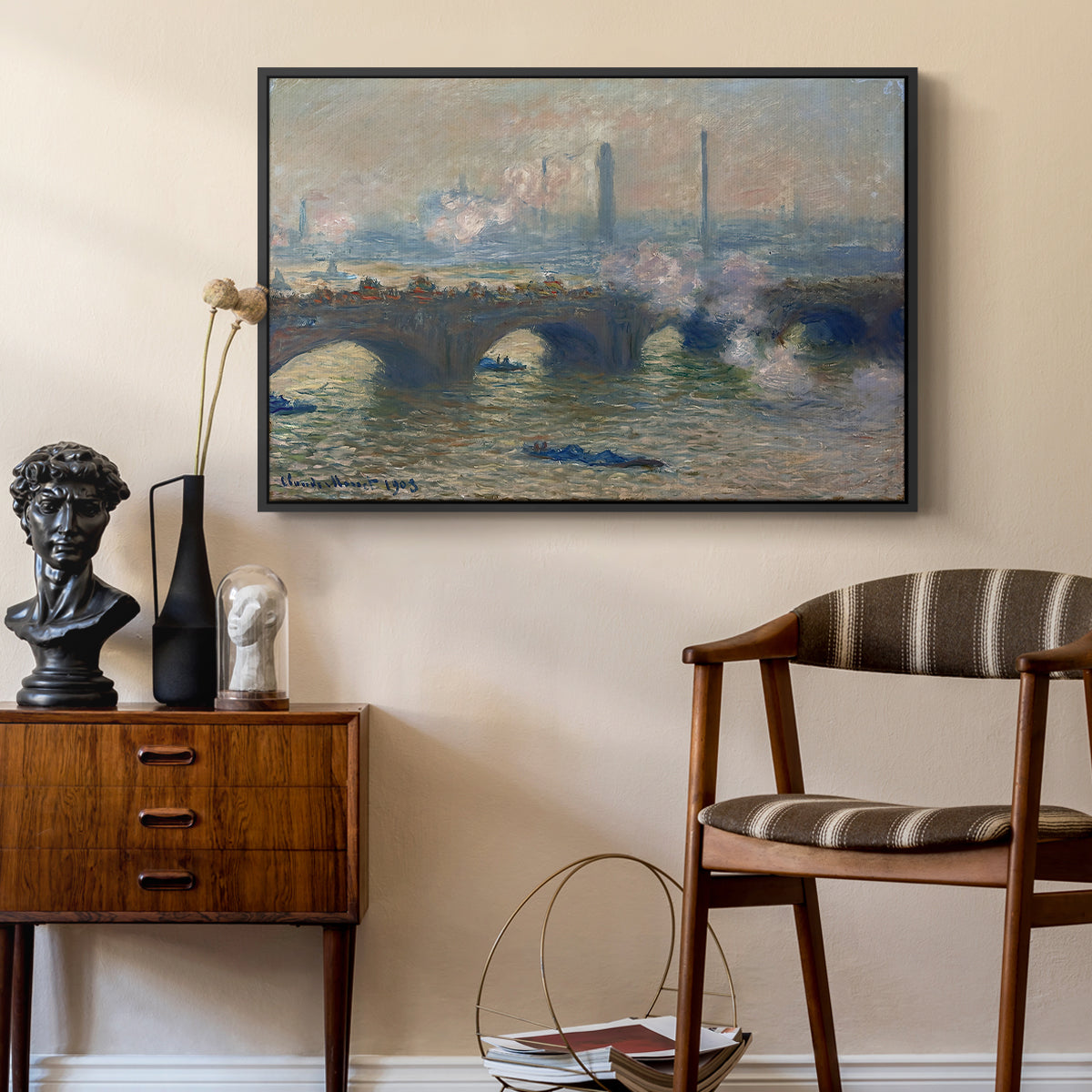 Waterloo Bridge, Gray Day, 1903 by Claude Monet as a black floater framed canvas featuring a river and bridge scene with diffused light and urban backdrop, styled above a mid-century console in a contemporary living area.