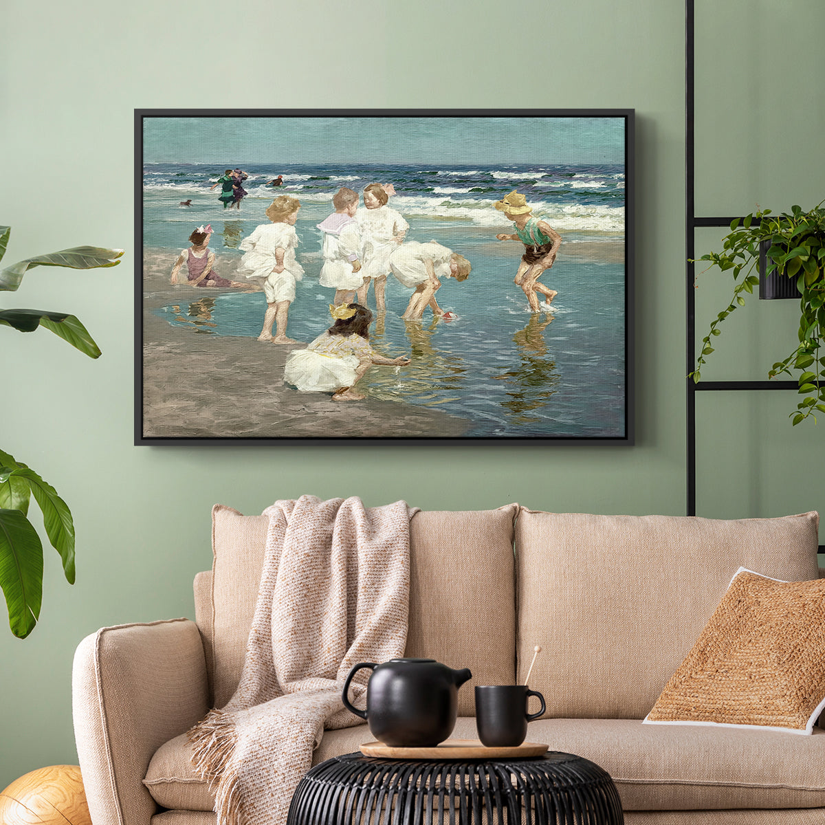 Black floater framed canvas featuring a lively shoreline scene with people gathered in surf, displayed above a sofa in a modern living room.