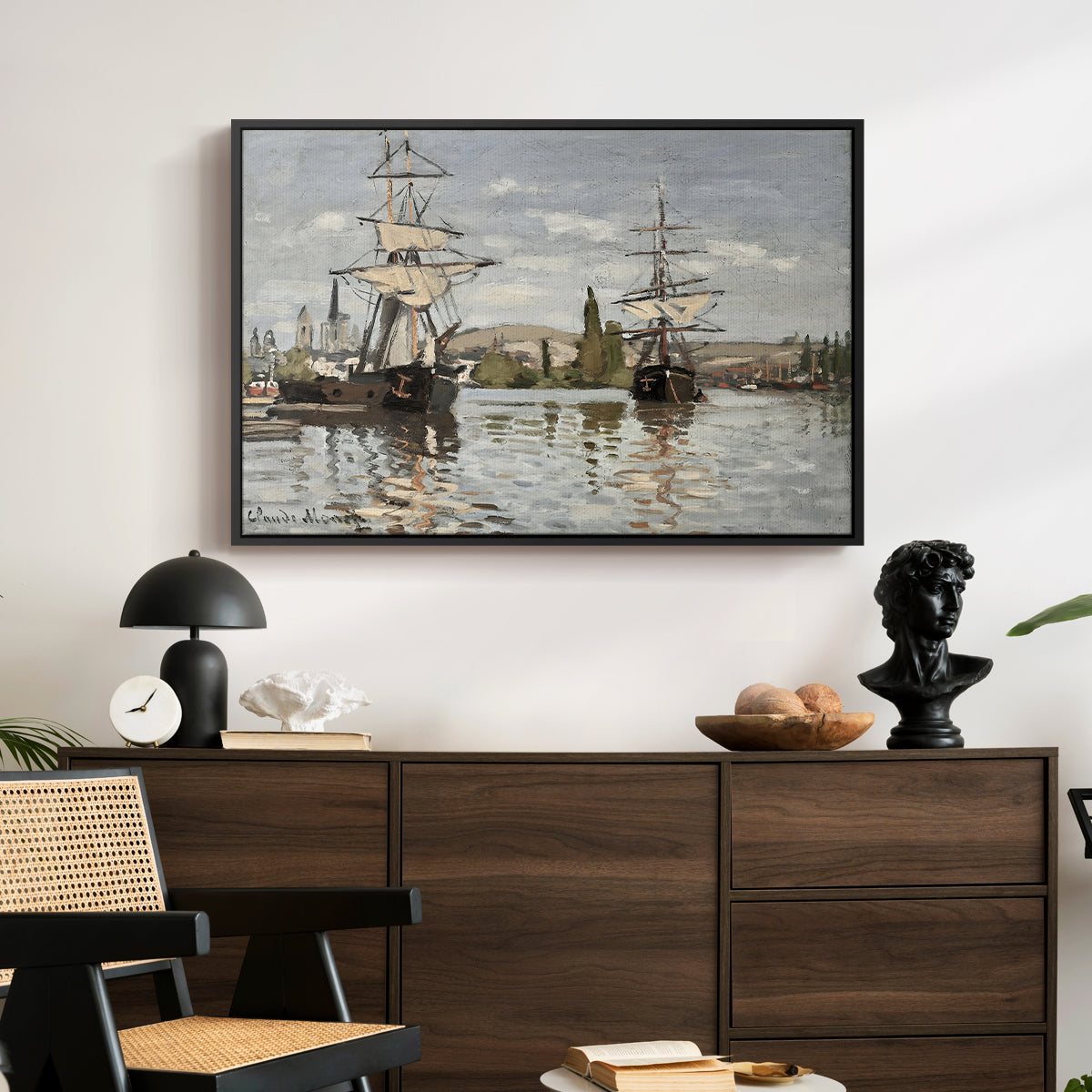 Ships Riding on the Seine at Rouen, 1872 by Claude Monet displayed in a black floater framed canvas above a dark wood credenza in an entryway.